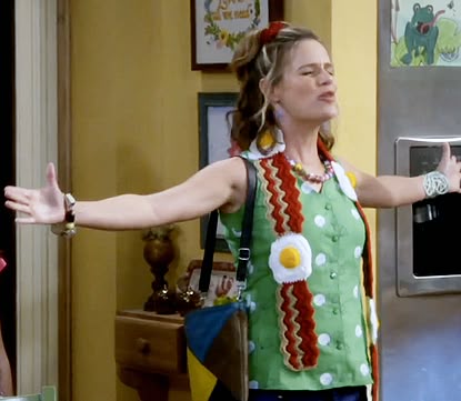 Kimmy from Full House wears a scarf that looks like a long piece of bacon with fried eggs sewn on.